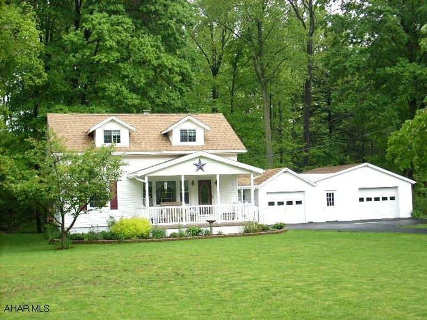 BEAUTIFULLY MAINTAINED CAPE COD. NICELY RENOVATED. NEW ROOF 2008, HARDWOOD FLOORS, THERMOPANE WINDOWS, UPDATED KITCHEN, VINYL SIDING. 1.08 ACRE. VERY PRIVATE ON A TROUT STREAM. 2.5 CAR GARAGE WITH WORKSHOP. COVERED FRONT PORCH. PRICED TO SELL.