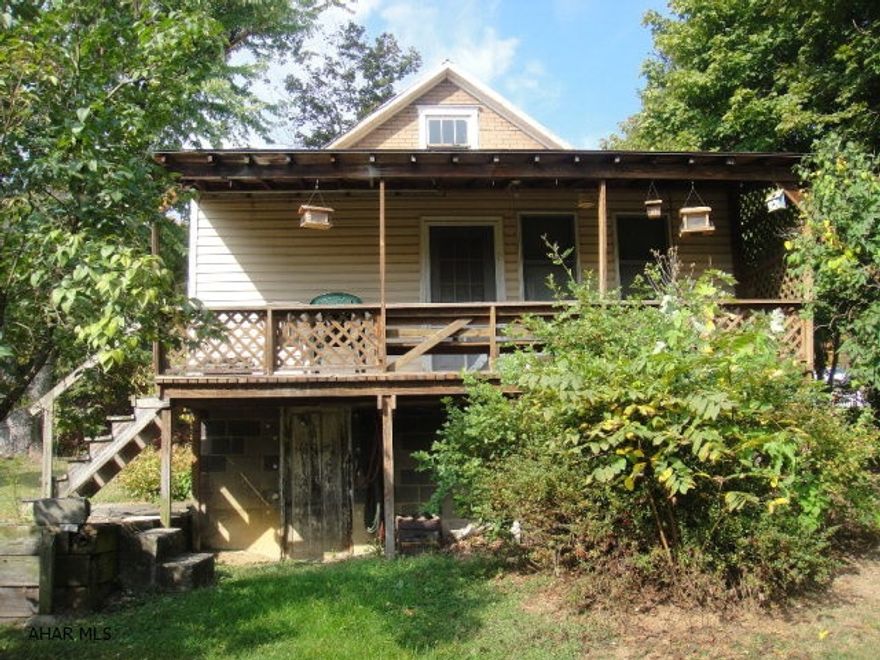 Cozy bungalow with inviting rear porch, 40'x24' metal garage and 14'x12' outbuilding on 1.28 acres. Heated garage has office, workshop and large space with 9.5'x7' overhead door and 10'x11' sliding door. Perfect for woodworking or car repair. Corner lot with access from 5th Street along the side. Property needs TLC.