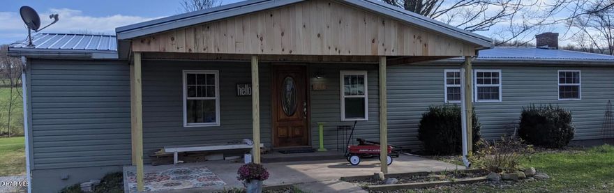 Warm and inviting one floor living! 1988 doublewide on a full foundation. Main floor features two bedrooms, one with an en-suite bath and main floor laundry, large eat-in kitchen and a spacious living area. Second full bath has a walk-in shower.  Basement could easily be finished into an entire second floor of living space with it's walk out doors, full-size windows and open staircase. Lot is over a half an acre with a carport, partially fenced area and a large barn outbuilding. Set up your showing today! (More photos coming soon!)