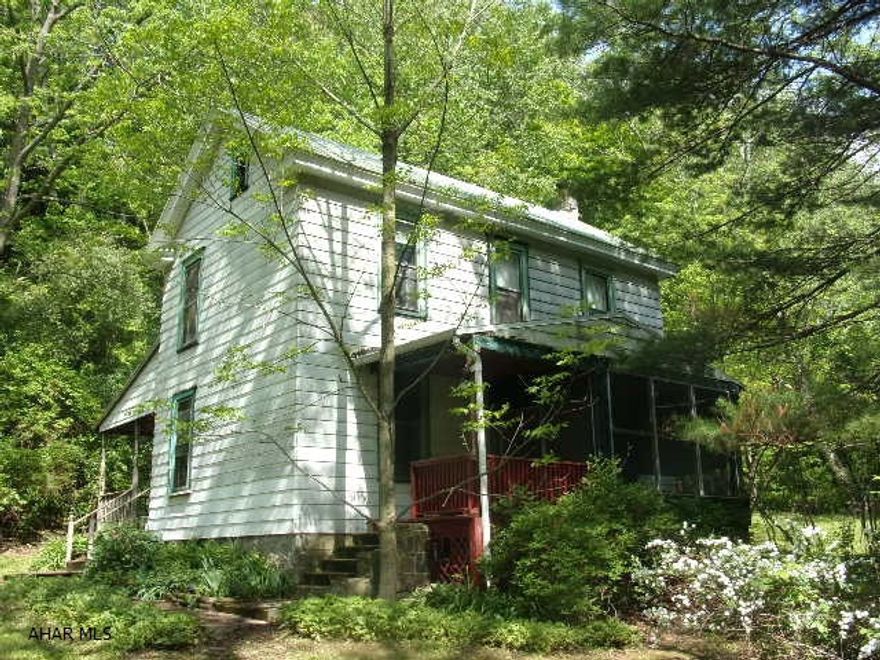 Lovely country setting just minutes from the City.  Home is surrounded by many varieties of mature trees, shrubs and perennials.  Watch the wildlife from your kitchen window.  Stream and pond on the property.