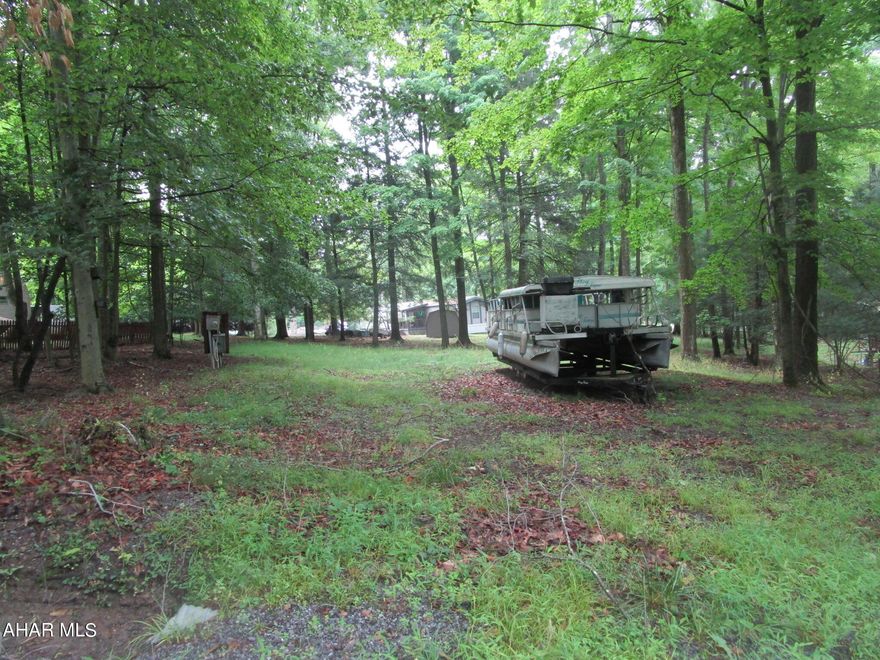 Nice wooded mobile home lot, approximately 1/3 acre with water and sewer already on the lot. 
Located in Glendale Yearound, a gated community with many amenities.  Adjacent to Prince Gallitzin State Park / Glendale Lake.