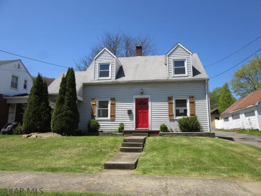 Quaint two story on corner lot- wood flooring, huge living room, modern kitchen, needs tlc