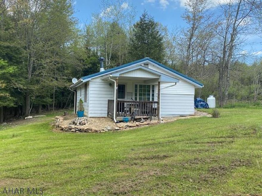 Are you looking for the perfect getaway spot? Perfect for hunting, wildlife watching, communing with nature, or just spending time with family and friends? Then look no further because this is the spot you've been looking for. This cute 2 bedroom camp bordering State Game Lands #228 and only 20 minutes from Gallitzin State Park sits on 1.3 acres. Don't want to leave the property? That's fine, you can enjoy the sound of the stream as it trickles past while you sit around the campfire. So much to do and enjoy, call today to set up your showing!