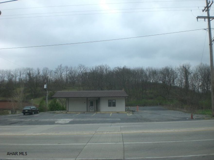 Super location at the Bedford Turnpike Interchange. Located next to the I-99 entrance and exit ramps. 1-story building with a partial bsmt. Could be an office building, professional use, medical/dental or retail.  .688 of an acre. Lots of parking. Excellent visability and exposure. Owner will lease or do a build to suit.