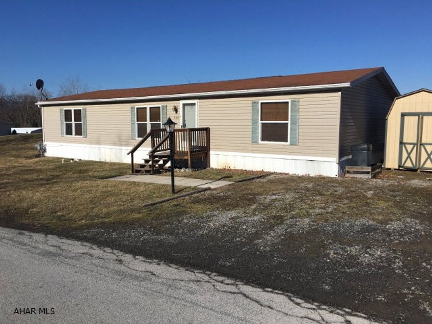 Very well maintained double wide home in Camelot Woods.  This home is located on a corner lot and includes a large deck with a retractable awning and an Amish built shed.