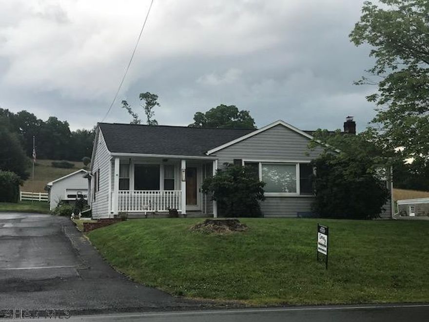 3 bedroom ranch style home with one car detached garage and  carport. covered front and back porch. newer windows and siding. hardwood floors. full basement, central air and hot water heat.