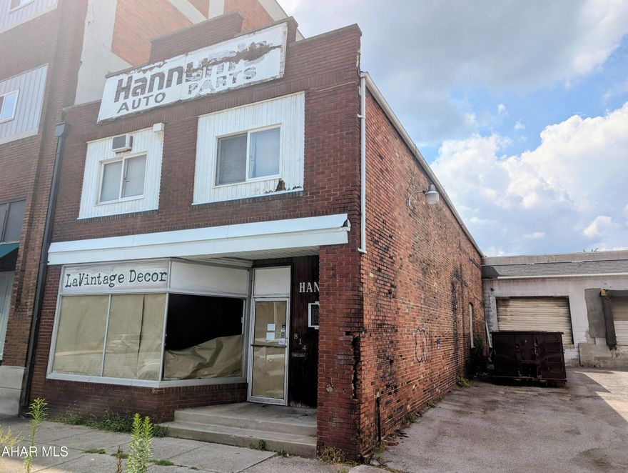 This expansive downtown property offers over 7,000 square feet of flexible space, ideal for a variety of commercial uses. The main level can feature a prominent storefront, perfect for retail or wholesale operations, while the rear section includes a spacious garage with a roll-up door and additional storage areas. The upper level offers space for a residential apartment or further storage. The layout supports multiple business models. This property is a well-located, in Downtown Altoona with endless possibilities making this opportunity well-suited for an owner-operator or investor.