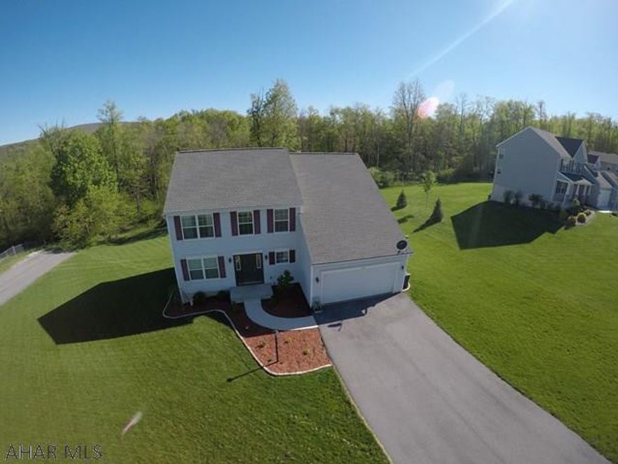 PRICE REDUCTION!  Seller moving out of state and must sell. Modern home built in 2013 with plenty of exciting features!  Situated on a large corner lot that abuts the woods, this home has 4 bedrooms, 2.5 bathrooms, 2 car garage, and over 2500 above grade square feet.  Large eat-in kitchen with stainless steel appliances, ceramic tile flooring, custom backsplash tile, and soft close cabinet drawers.  Hardwood floors cover the foyer and dining room.  Living room has surround sound rough in. Master bedroom has a walk in closet, ensuite bathroom with a water closet, garden tub and separate shower. Ceiling fans in all 4 bedrooms with touch pad controls.  Walkout basement to the rear of the house with double doors. Security system, central vac system, central air, and natural gas heat.