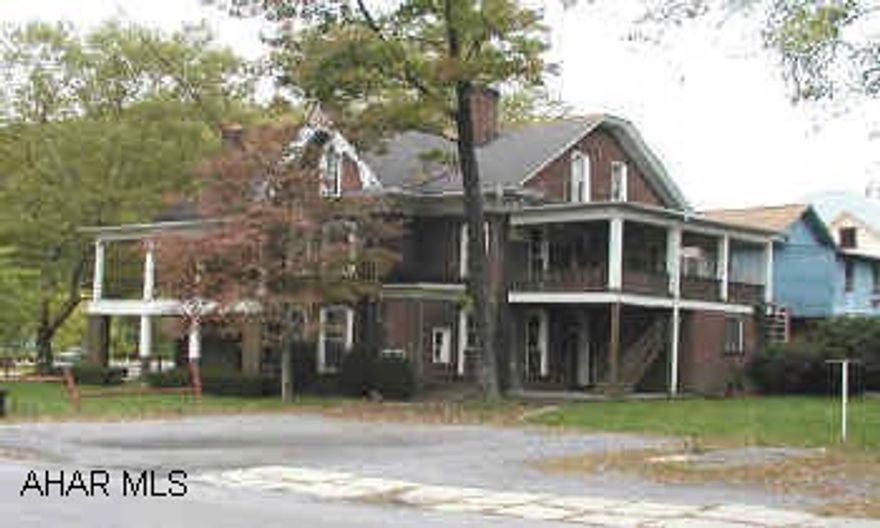 three story brick tri-plex with sep. elec .Home could be restored to single family. Stone fireplace in living room.