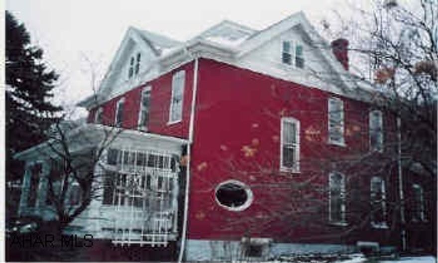 Stately brick victorian era home with original oak work and wood flooring.  Oval window, sun porch, storage room in attic.