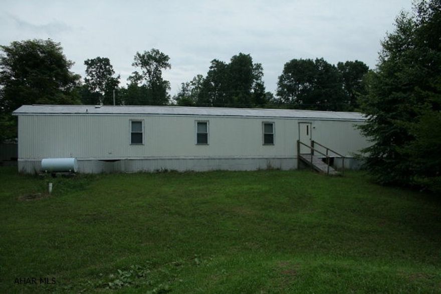 This well maintained, 14 x 80 single-wide on 2.022 acres of partially wooded land is ready for you to make it your home! All new windows, new front door and new flooring in the kitchen and bathrooms. Walls are primed and ready for your choice of color. Above ground swimming pool with accessories and storage shed are included!