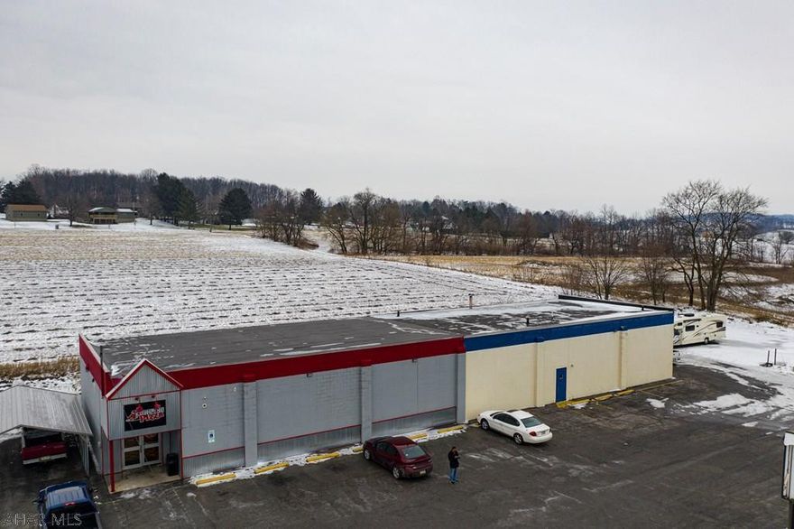 Commercial building in a high visibility location consisting of 5,320 square feet with large overhead door and 17' ceilings. Presently used as an RV service center and pizza shop. Building has plenty of parking and 5100 annual average daily traffic count. Endless possibilities!