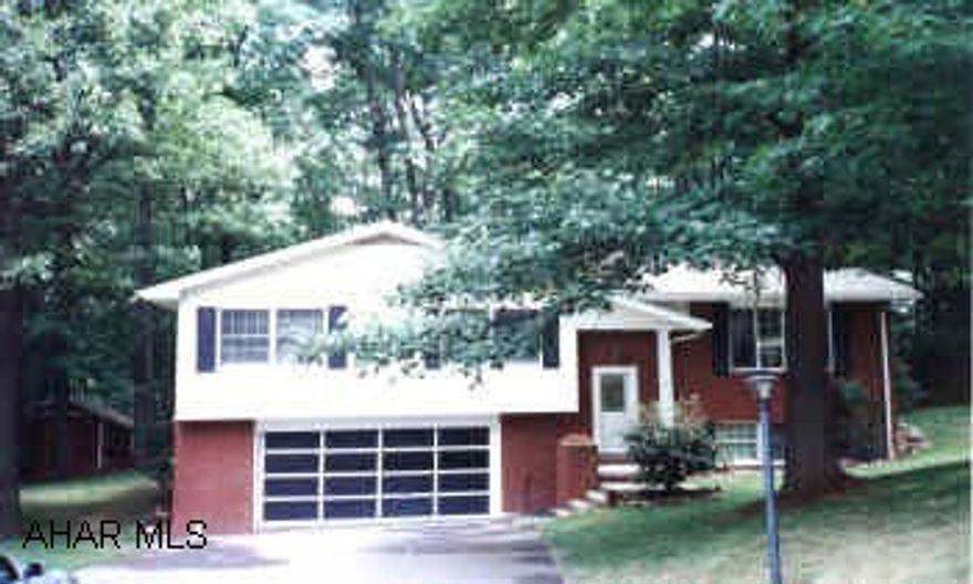 EXCEPTIONAL BI-LEVEL ON LARGE WOODED LOT. MODERN KITCHEN WITH PERGO FLOORS. 1ST FLOOR FAMILY ROOM, PLUS FINISHED BASEMENT WITH FIREPLACE.