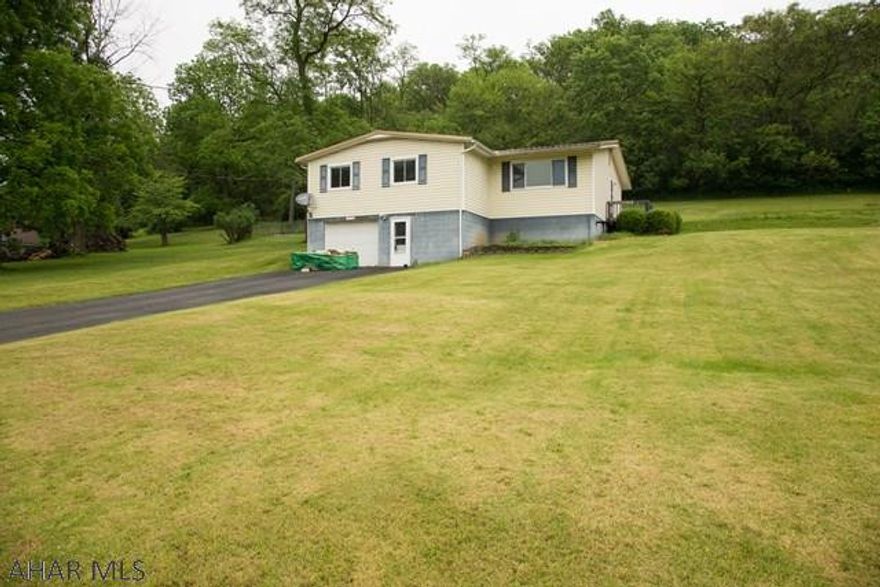 Here is your chance to own a 1 owner raised ranch home that has beautiful oak trim and doors throughout. The three spacious bedrooms have ample closet space. A finished family room with a pellet stove in the basement add to this incredible value. Hollidaysburg school district too! You can enjoy beautiful days out on the deck. An integral garage means you won't have to clear snow off of your car before work! Easy access to 22, 99, 764, but on a private lot. Call the listing agent for your private tour today!