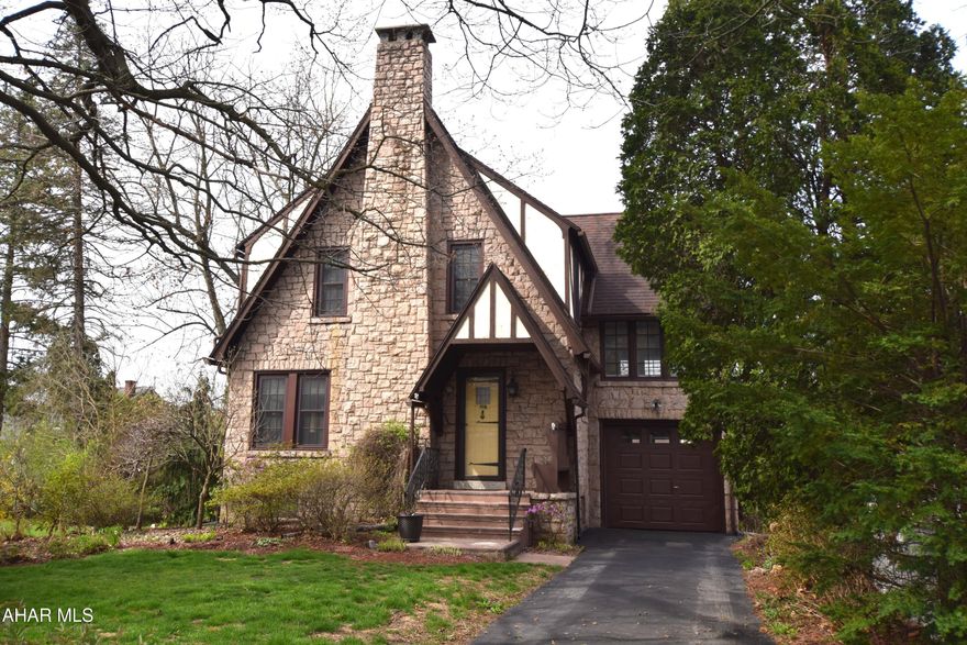 This beautiful Tudor style home in the mansion park area  features the type of character and charm rarely seen in our current marketplace.  Incredible woodwork,  hardwood floors,  and a stunning  stone fireplace combine to make this home stand out among the others currently available.  The second floor sunroom is the perfect spot for a home studio, office,  or hobby room.   Second floor bath is recently remodeled.   Basement is the perfect gaming room for kids  with full bath.   Mostly all newer windows.  Plenty of storage space in the attic for all of your treasures and seasonal decorations.   Attached garage has new garage doors.