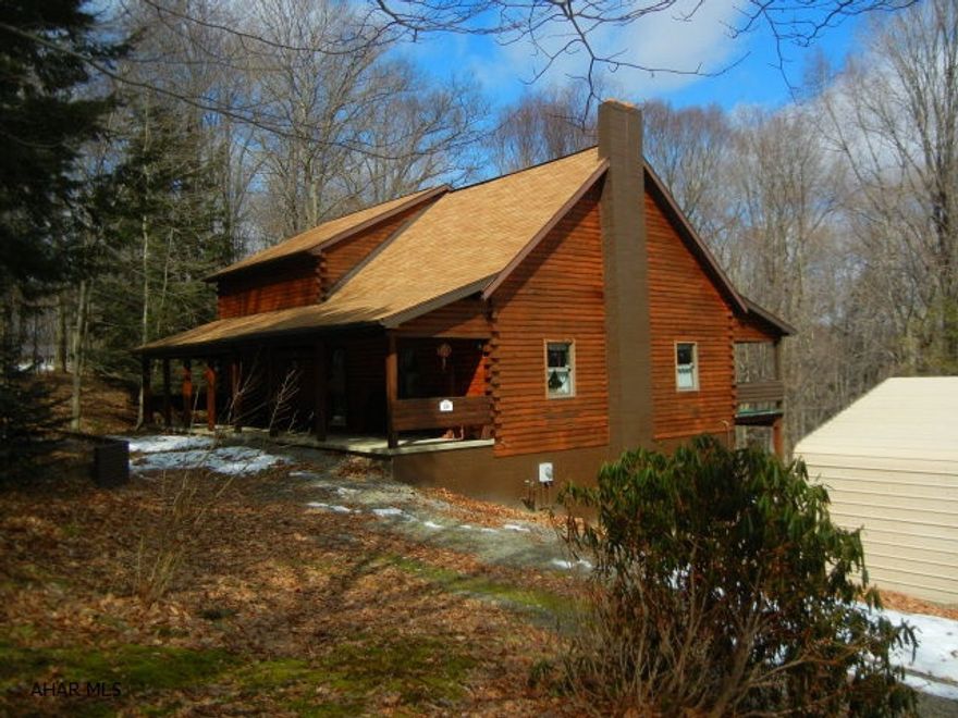 One owner, log home on 2 acres.  Beautiful condition, newly painted wood exterior.Kitchen has lots of storage space, two-level bar area.  Elevator to main & bsmt levels.  Piping exists to convert back to bath or main level laundry.  Roof replaced approx. 2004, some new tilt-in Anderson windows.  Dues $140/qtr.  Water/sewer $80 mo.