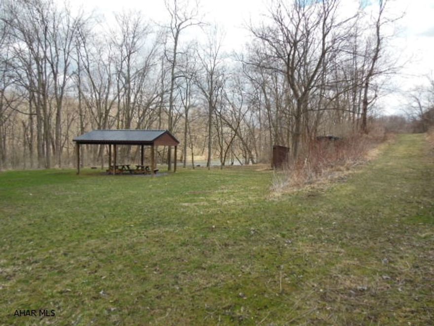 Special opportunity to have ~15 acres of ground along Juniata River in Williamsburg. Woodbury Township, Boarders Rails to Trails!  Replenishing top quality Basher Top Soil that can be mined and sold for profit, or can be used for rented camping, fishing sites. Has a pavilion, mountain water well used for steam engine locomotives in earlier days, shed (outhouse rarely ever used), and is definitely a flooding area. Please only qualified buyers because of keyed entrance. Refer to Pictures please, some woods.....  Sign along Rails to Trails.  Any reasonable offer considered.