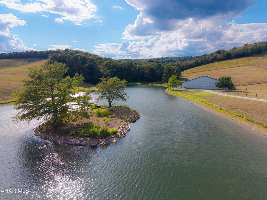 A Once-in-a-Lifetime Bedford County Estate

Set against the rolling hills of historic Bedford County, this renovated farmhouse is gracefully sited on 150 Â± pristine acres, with panoramic views that capture the very best of Pennsylvania's countryside. Surrounded by open sky, woodlands, and rolling fields, the land itself is the true crown jewel of this estate.

At the heart of the property lies a massive, private pond that feels more like a shimmering lake, a rare natural treasure where every step around the shoreline feels like entering another world. For those seeking even greater views, a gentle hike to the hilltop reveals a magnificent stone pavilion, crafted with stately pillars and a grand stone fireplace. From here, the eye travels 11-12 miles in every direction across pastures, treetops, and open sky-unmatched vantage point of Bedford County's landscape.

The farmhouse itself rests closer to the road, providing convenient access, yet it is perfectly positioned to overlook the lake, creating a peaceful and picturesque backdrop from the home. Beyond, the property unfolds into fenced pastures with high-tensile fencing, tillable acres, and spaces designed for both agricultural and equestrian pursuits. A beautifully restored barn clad in durable Hardy board siding blends rustic charm with modern resilience, while the oversized three-car garage provides exceptional storage and functionality.

A true hunter's and nature lover's paradise, the land is alive with wildlife. Deer, wild turkey, bear, and many other species roam freely, offering endless opportunities for outdoor recreation and a deep connection to nature.

Despite its accessibility, the estate offers a remarkable sense of retreat. With close proximity to I-99, Route 30, and the Pennsylvania Turnpike, travel to Washington, D.C., Pittsburgh, Baltimore, and Philadelphia is surprisingly convenient. The property is also just minutes from one of Pennsylvania's finest resorts, Omni Bedford Springs, offering fine dining, golf, and wellness amenities.

For the equestrian enthusiast, this property is unrivaled: a huge indoor riding arena with 15 horse stalls overlooks the lake, creating a breathtaking setting where horses and riders alike can thrive.

This is not just a property, it is an experience. A place where natural beauty, abundant wildlife, and equestrian excellence converge into a lifestyle of unmatched peace, recreation, and possibility.