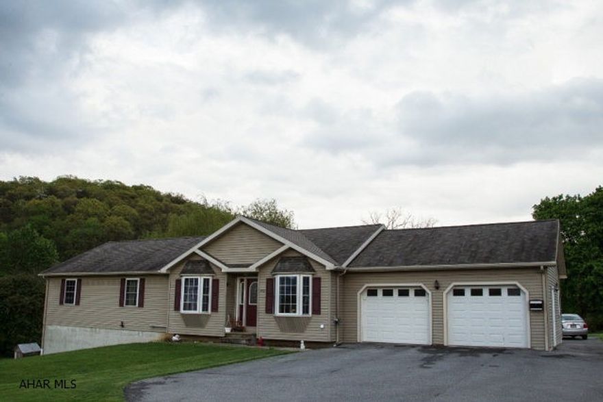 This large, modern, and move in ready home is just 5 minutes from Lake Raystown!  It features vaulted ceilings and an open floor plan for the living room into the kitchen and dining area.  There is a half wall section in the living room that could be used as an office nook.  There are three bedrooms on the first floor and one in the basement.  The foundation is a poured concrete foundation.  A spacious backyard with splendid views just adds to the value of this home.  An attached over sized two car garage gives you plenty of space for your vehicle storage needs.  You must see this home!