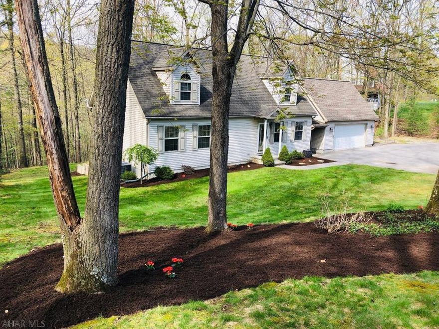 Laurel Heights Development - Conveniently located and perfectly placed in a serene setting on 1.67 Acres - Enjoy this Cozy Cape Cod, 4BR, 2BA.   Features hardwood floors in LR and Dining Area and Kitchen.  2 BR's & Full Bath with soaking tub and separate shower on first floor.  2 Lg BR's and Full Bath on 2nd Level.  Large private, composite deck and patio overlook private wooded area.  The detached 2 car garage is oversized and features a high ceiling for extra storage.  Walk out basement - lots of potential!!  New Hot Water Tank 2016 - New Heat Pump in 2017 - Rough in for a bath in the basement.  Yearly snow removal fee for development $100.  Deed Restrictions attached. Conveniently located midway between State College and Altoona!  Won't last, priced to sell!!