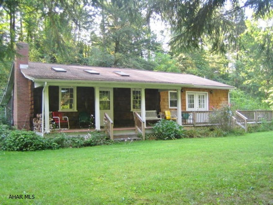 Fantastic Spruce Creek property on 1+ acre lot. 1 story shake home with open floor living and skylights throughout. Living room w/ beautiful brick FP opens up to eat-in kitchen with center island and open dining room w/ custom built-ins. Large, relaxing screened porch, front porch and wrap-around wood deck all overlooking tranquil Spruce Creek. 2 BR guest house with kitchenette and bath. Fishing rights do not convey – see listing agent for details on possible fishing rights.