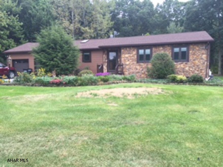 Stone and vinyl rancher set on wooded 1.68 acre lot. Ceramic tile and natural oak, finished basement, new roof, detached garage.