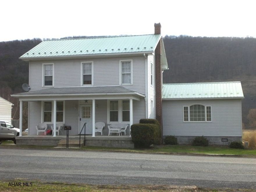 Exceptionally well maintained two-story home.  L/R, D/R, Kitchen w/new antique white cabinets, first floor master bedroom suite w/master bath.  Master bath has two showers.  Two more bedrooms and a den or bedroom and full bath on second level.  Full walk-up attic, 100-amp electric, walk-out basement, rear porch w/trex decking and front porch,  1-car detached garage, concrete driveway, oil hot water heat and a great view off the back porch.  This property needs nothing!