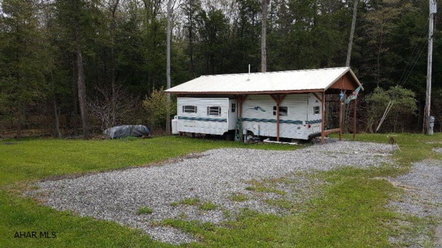 2000 Nomad camper in great condition and well taken care of on two lots inside Glendale Yearound. This camper is under a pavilion which has a deck. Nice flat lots with a stream right behind. There is also a shed on the property. Glendale Yearound is a gated community minutes from Glendale Lake. Community pool, basketball, tennis, dog park, and more.