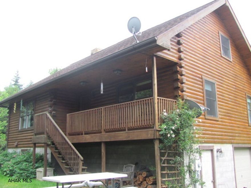 Custom built 1 1/2 story log home, secluded on 26.66 +/- acres. Temp-Cast Masonry stone fireplace divides the large living room and kitchen. Vermont Verde Antique serpentine stone kitchen and bath counter tops custom cherry cabinets. Pine plank random width flooring throughout. Full walk out basement is plumbed for future bath. This is a great hunter's paradise or weekend get away.