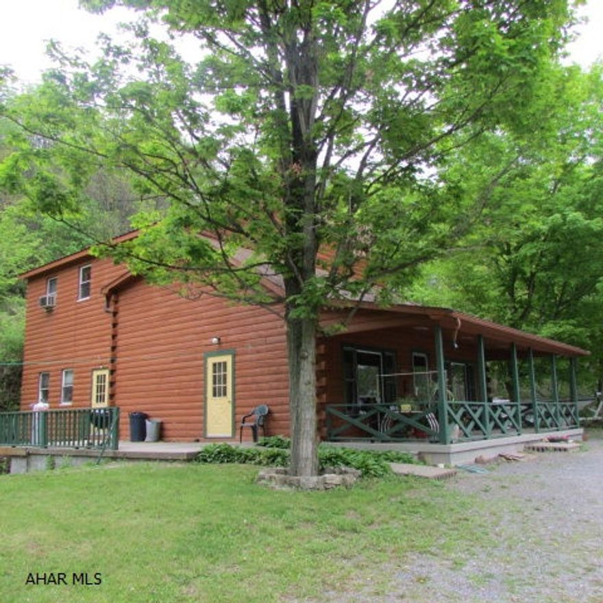 Log home on 2 acres with 500' of road frontage; area for boat storage.  Lots of possibilities with this property. Previously a restaurant with apartment above.  Main level has dining area on right with two half baths.  Left side is counter/shop area with the prep area behind that.  The large commercial kitchen is at the back.  Apartment above has a loft area - intention was for a kitchen; living room, full bath and two bedrooms.  A deck on the left side; patio on the right. The integral garage can store a boat, etc. Part of the basement is heated with hot water baseboard, hook-up for woodstove, plus outdoor furnace.  Plenty of parking.