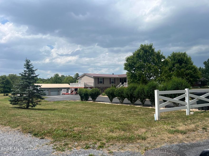 Beautiful raised ranch double wide with full finished basement on a 1.65 acre lot. The home contains 4 bedrooms,, 2.75 bathrooms, living room, dining area with fireplace, eat in kitchen and laundry area. The basement was recently finished and contains a large game room, office (gun room) bedroom and storage room.  The acreage is in lawn with a paved drive. A large three car heated garage with lots of paved parking sits behind the house. A carport is there for camper storage. Lots here for the $$.