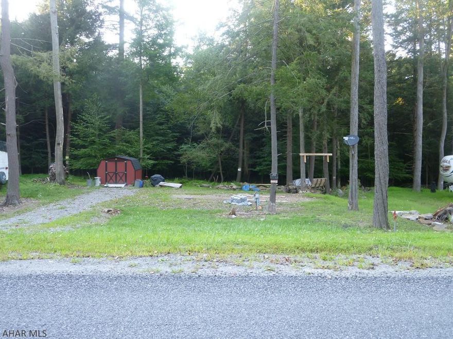 Place your camper against the woods to enjoy nature.  Seller is leaving a shed, swing, picnic table and golf cart.  Room to set your camp to suit your needs.  City water and sewer.  Located in Glendale Yearound, a gated recreational development adjacent to Prince Gallitzin State Park / Glendale Lake.  Six miles from Rock Run ATV Park.