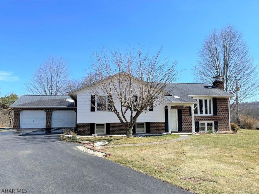 One owner, well maintained home just minutes from downtown Bedford!! The main level of this home features a living room, dining room (open to LR and Kit), kitchen, four bedrooms and two full baths. Lower level features a family room with large wood burning stone fireplace, office/den (can be additional bedroom or guest room), and a large laundry room. Heat pump with central air, 200-amp electric, well and private septic. Large rear covered deck to relax and enjoy peaceful mountain views. Oversized two-car garage w/ auto openers, and blacktop driveway. Replacement windows, architectural shingle roof, vinyl siding and brick veneer. Central location close to downtown Bedford, short drive to game lands, golfing, hiking and biking trails, and major roads.