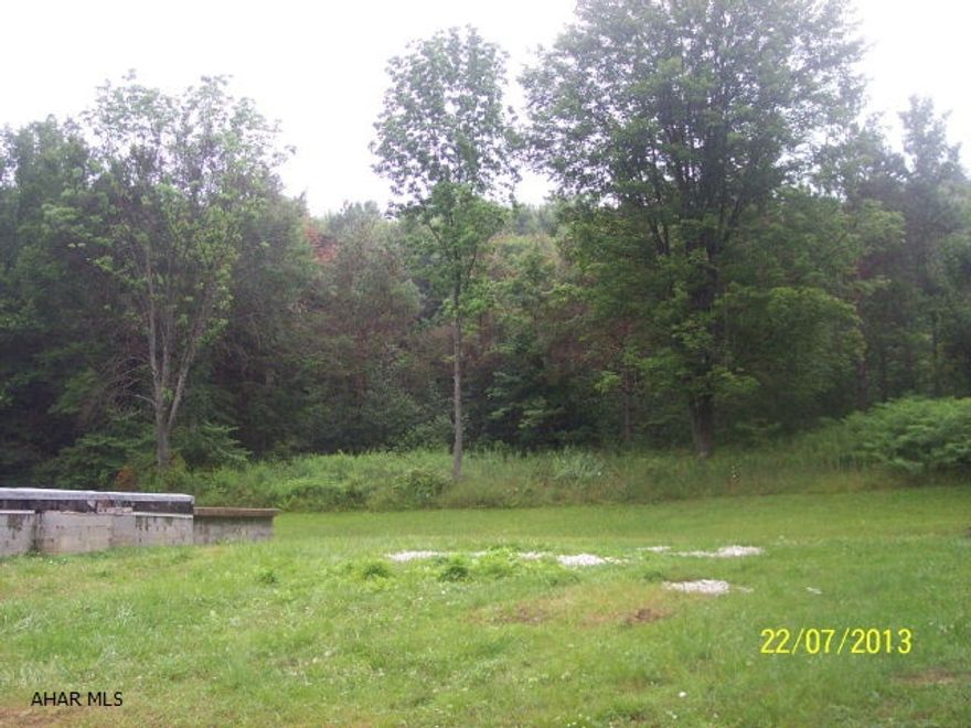 0.9 Acres with public water and sewage and existing foundation.