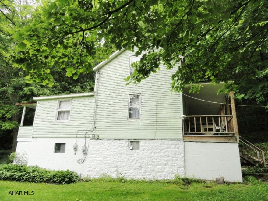 Quaint 2 story, 2 BR, 1 BA home in quiet rustic setting. Located on 1.46 acres in the town of Claysburg. Large updated eat-in kitchen, newly remodeled bath, dining room and large living room. 2 BR on 2nd floor. Large covered porch, detached oversized garage. Property includes large cleared lot with address of 512 Basswood Drive, a great potential building site and a wonderful opportunity for building and/or investment rental in a quiet peaceful neighborhood.  Very motivated seller.