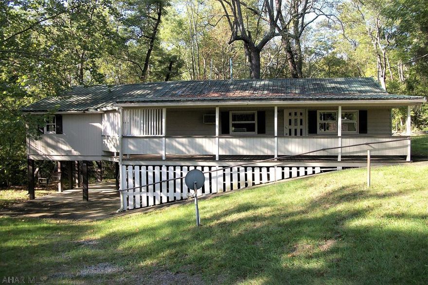 Are you looking for a waterfront getaway or a year round residence? Check out this charming, ranch home on the Raystown Branch of the Juniata River. Located not far from downtown Bedford, Interstate 99 and the PA Turnpike, this home is rural but close to town.  Relax on the covered front porch or sit in the swing on the covered patio & enjoy your morning coffee or the evening beverage of choice. This home offers one floor living, with tongue & groove knotty pine walls that require little maintenance. The open concept kitchen and dining area is spacious. The back bedroom has waterfront views. The partially finished basement has a 3/4 bath and a bonus/bedroom.  Come see this little slice of paradise; you may just have to have it. Property being sold 'as-is". Seller doesn't know the property.