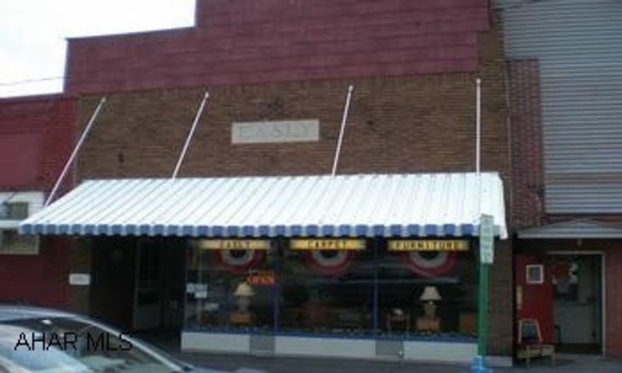 Main Street location in Hastings. Currently used as furniture store. Remodeled multiuse building in good condition. One car garage with alley access.  Shop area. Second floor could be used as apartment.