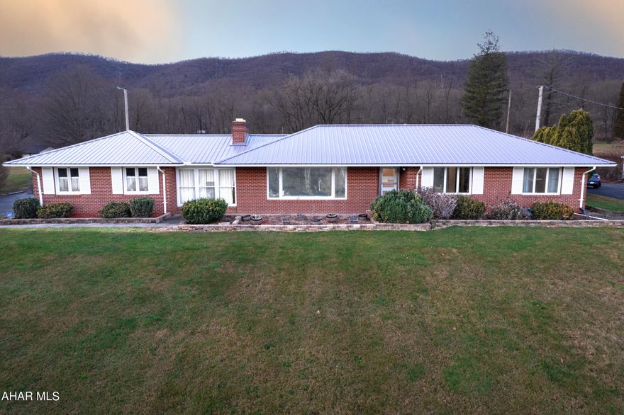 Well built, quality brick ranch home resting on just over one acre in Bedford Township. Entry foyer with oak floors; large living room with wood burning fireplace, a picture window to enjoy mountain views and hardwood floors; newly updated kitchen with quartz countertops and stainless appliances; dining area; main level laundry room; three bedrooms with updated carpet; one and one half bathrooms; and a fully enclosed breezeway. Full basement with a beautiful newly finished rec. room and a large unfinished room offering ample storage. Oil hot water heat; mini split heat pump systems with central air; and 200 amp electric. Two-car attached garage, two-car attached carport, and a storage shed. Many new updates throughout this home!! Conveniently located in Bedford Township with easy access to supporting amenities, major roads, the Omni Bedford Springs Resort and Golf Course, and PA/MD border.