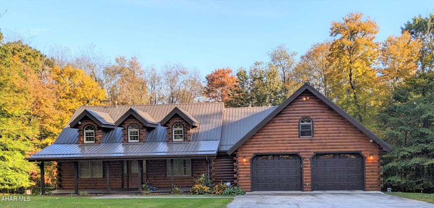 Absolutely STUNNING Log Home in the Central Cambria School District! As you walk through the front door you are immediately greeted with a large GRANDEUR great room featuring hickory floors, hickory cabinetry, pine wood ceilings, and many skylights with natural lighting. Kitchen includes cement counter tops, built in oven and microwave, and large stove top. Open floor plan with an all-season room, fireplace and beautiful scenery adorn the room.  There is a loft that can be used as an office or den, with an attached porch. Home includes three bedrooms and 2 full baths and one 3/4 bath.  The primary bedroom includes a beautiful ensuite.  
A large finished basement boasts a NEW kitchen and large game room plus the 3/4 bathroom. From the finished basement, walk out to an enclosed  5-person 400 gallon hot-tub year-round! Amenities include a whole house Generator, HEPA Filter and Humidifier; Central Vac; 2 Propane fireplaces; Reverse Osmosis Water Filter;  and an Alarm System. Home also includes three heat sources: Oil, Hard Coal and Heat Pump Furnace with A/C, with two Hot Water tanks. New Oil Burner 2022; New Metal Roof 2017; A/C replaced 2022. A 2400 sq foot  garage enables various usages. A beautiful driveway through the trees and surrounded by an apple orchard leads to this beauty, all on 24 acres and mostly wooded.
Call to take a private tour.