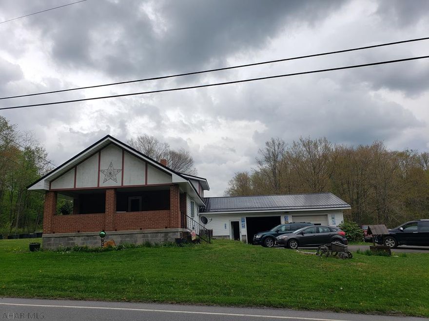 Great location with acreage! With some updates, this property would make a great home! The home has a newer furnace and metal roof. The over sized 2 car garage is perfect for any hobbies and storage. Public water and sewer is coming through and seller will pay tap fees with accepted offer. Call listing agent for more information.