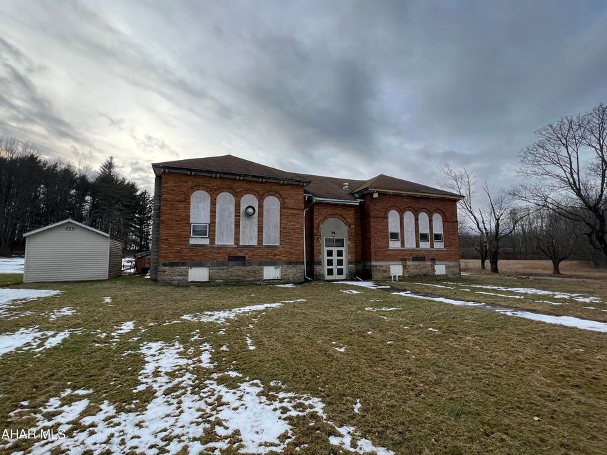 Brick 1.5 story former school building converted to a house of worship. Could continue that use or be converted to many other uses.  Shingle roof has been partially replaced, exterior is brick, interior has many updates including most mechanics. Large auditorium with stage, 5 offices, kitchen and dining room, bath rooms, and additional finished rooms, Heat pumps and oil hw heating. Security alarm and circut breakers. Partial basement. Great building for the $$. All on approx 10 acres of land!