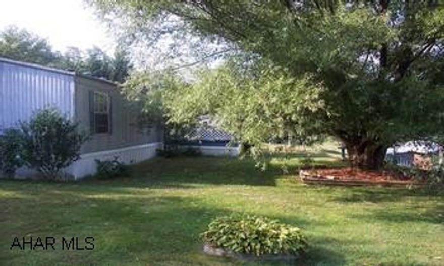 2000 Redman mobile home 14x60 , 2 bedrooms,1 bath,  large living room, with catherdral ceilings, covered porch and  is a flower lovers dream.  All on 1.08 acre. In addition to the mobile home, there is a heated workshop 16x 20 with electric.