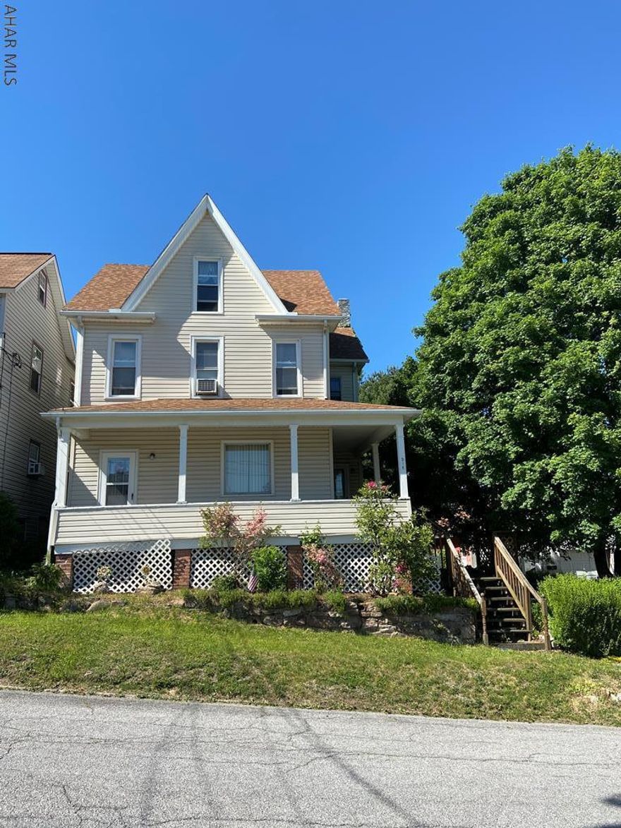 3 bedroom, 1 bathroom house with covered porch, fenced yard and detached garage.