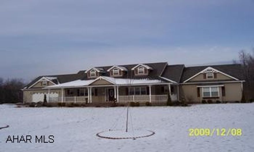 Vinyl sided ranch home with fireplace, 2.5 baths and 4 car garage.