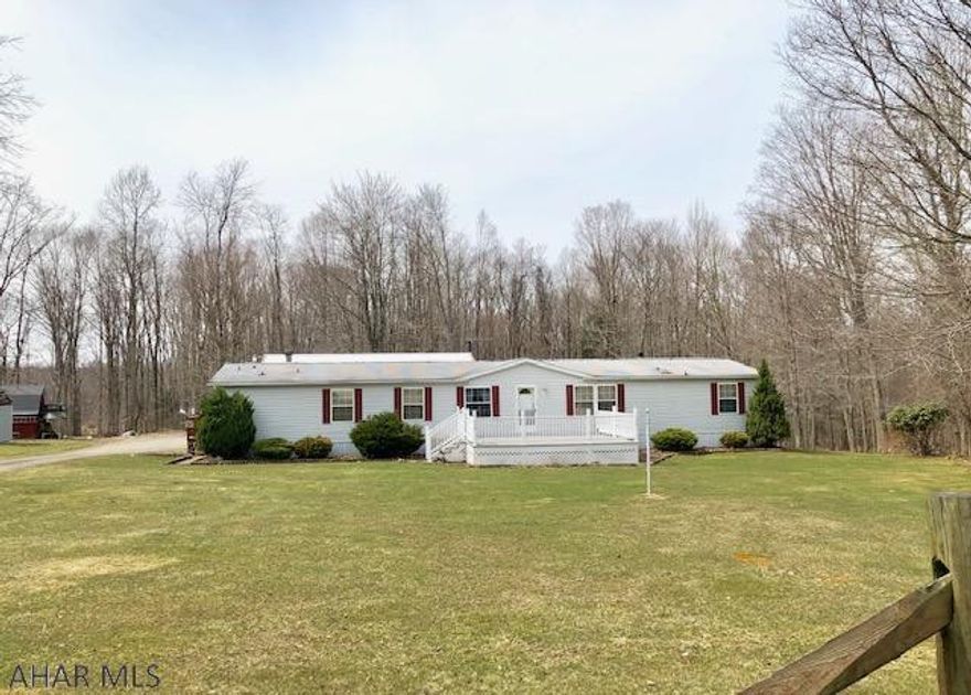 Exceptionally well kept 28 X 80 Double wide home.  Large 2 car detached garage.  Enter this home to find large rooms, kitchen with island, bonus room that would make a great home office.  Lovely family room with fireplace.  Master bedroom w/large bath w/ sunk in tub.  Central air a plus. Over 2000 square of living space. lots of closets. Country setting. The large detached garage has a half bath. Large front deck , great for entertaining!