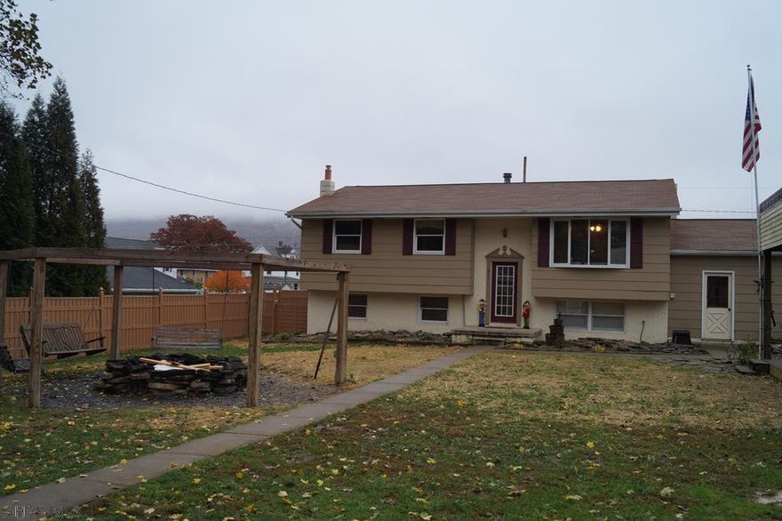 PRICE REDUCED!!!! This home has an energy & warmth that invites your friends and family to spend an afternoon, evening, and night. With a living-room of rich hardwood plank floors and a spacious, updated, tiled eat-in-kitchen.  This 3 BDRM, 2 BA home includes a downstairs family room with pool table, natural-gas brick fireplace, a full kitchen including a deep freezer and a huge bonus room with endless possibilities.  The exterior living area continues with a hexagonal pergola swing fire pit, an open-air covered grilling station with mini-refrigerator and sun decking surrounded with privacy fencing.  Not to mention the back deck, attached garage, and concrete drive all located in a quiet, charming, and oh so convenient location. Just moments away from anything or anyone. Stop by!