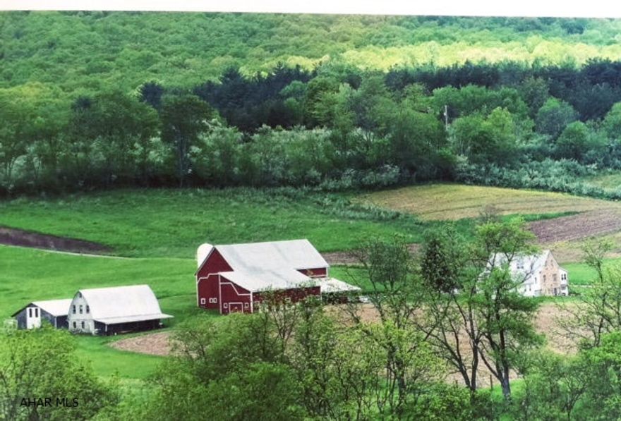 Within a 10 minute drive of historic Bedford sits this 2592 square foot stone home on 21 acres. The tranquil setting and gorgeous views that surround the home ensure the peace and solitude one expects from such a unique home. A main floor master bedroom, bathroom and laundry room allows one floor living.  A wall of windows in the sunroom and a fireplace found in the kitchen add to the character. The property would make a great horse farm or hobby farm. Outbuildings, which include bank barn, flat barn, 2 frame sheds and large pole building, are in excellent shape. Ground has been organically farmed... great tillable acres available.