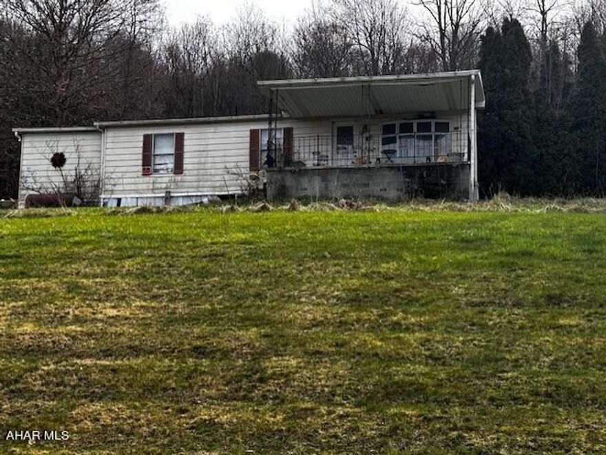 This 1982 doublewide offers a unique opportunity for someone with a vision and sense of adventure.  This home has many issues and a leaky roof and would need a trashout in order to decide if it is salvageable.  For anyone wanting a great lot to build a home, this may be the property for you.  It is 1 acre with public sewer and a well.   Don't miss out on the opportunity to turn a tear-down into a triumph.  Selling AS-IS