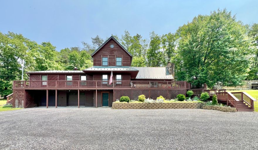 Beautiful custom-built cedar home with stunning views! Enjoy mountain living at its best in this spacious home on over 8 private acres.

The main floor features a welcoming Great Room with an impressive natural stone fireplace and cathedral ceilings, a dining room, and a kitchen—with a breakfast bar, stainless steel appliances, and granite countertops—plus French doors leading to the family room. The master suite includes a propane fireplace and access to a private three-season porch. An extra bedroom, half bath, and another three-season sunroom add to the home's versatility.

Upstairs, you'll find a second master suite, an additional full bathroom, and a charming loft overlooking the Great Room's stone fireplace. The walk-up, partially finished attic offers additional storage or expansion opportunities, while the walk-out basement with a large integral two-car garage, workshop, laundry area, and storage space enhances functionality.

Step outside to enjoy the wraparound deck that showcases the picturesque views and is perfect for gatherings and outdoor living. The property features an outdoor stone BBQ area, an above-ground pool for summer fun, an approximately 15x40-foot barn with a cement floor and three small animal stalls, a large 8x40-foot enclosed woodshed, over 20 assorted fruit and nut trees, and ample open areas for gardening and recreation. Hunt on your own land or in multiple nearby PA and MD State Lands, plus enjoy nearby fishing in both Flintstone and Town Creek.

Close to I-68, this home is located just 10 minutes from Rocky Gap Casino, Resort & Golf, as well as Buchanan State Forest and the PA Mid-State Trail. It provides an ideal escape to nature with easy access to amenities and outdoor adventures.