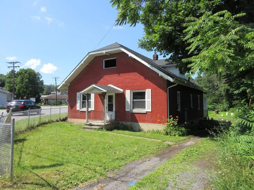 Busy location on Pleasant Valley Boulevard. Greenwood area 1 story brick home is commercially zoned and large adjoining parcel is zoned residential. Entire parcel could be rezoned for commercial usage. Check with Logan Township for details. New carpeting and paint, but needs some work. Loads of possibilties.